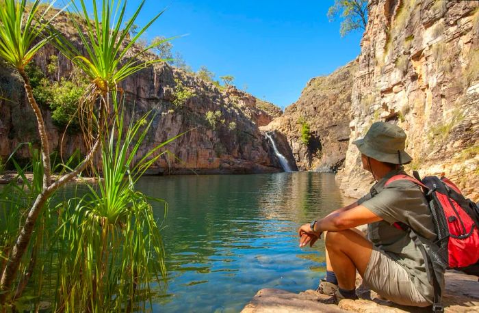 A person gazes over the rock pool at Barramundi Falls, Kakadu National Park, one of the lakes in the area free of crocodiles