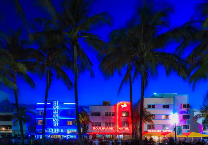 Illuminated hotels lining Ocean Drive at South Beach, Miami Beach, Florida, USA