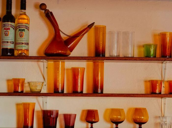 Shelves adorned with amber glassware, featuring a poron.