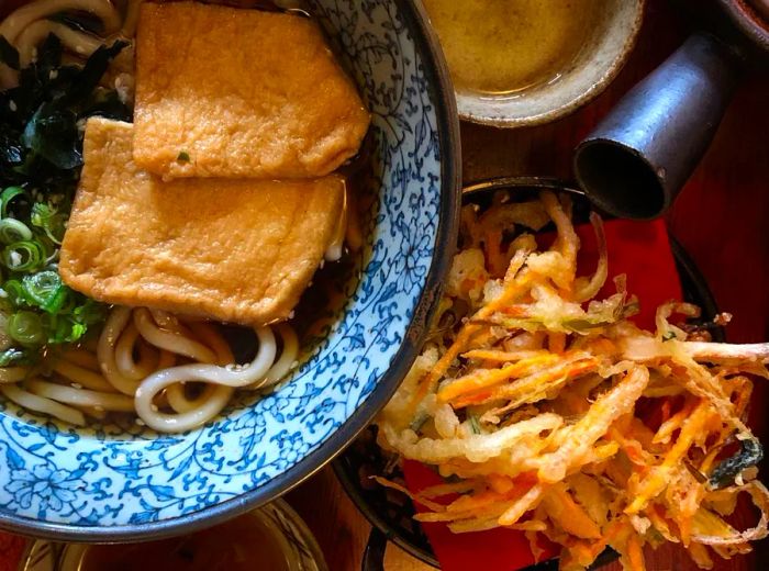 A bowl of udon paired with kakiage tempura on the side.