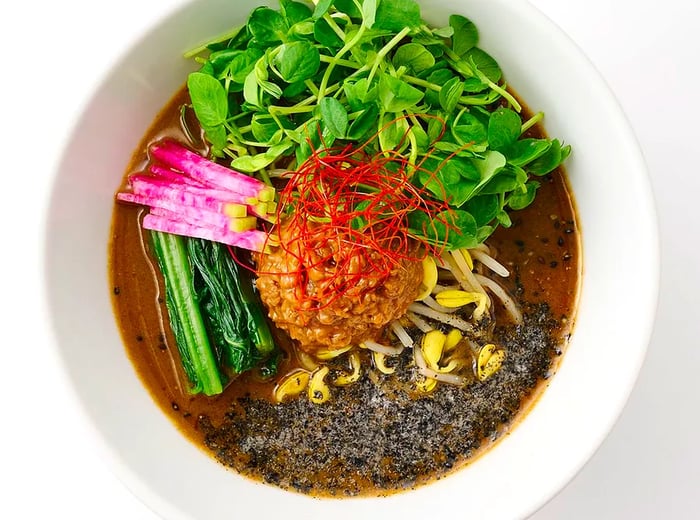 An aerial view of a ramen bowl adorned with various toppings.