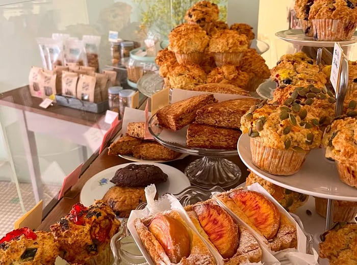 An assortment of muffins and baked treats beautifully arranged in a bakery display.