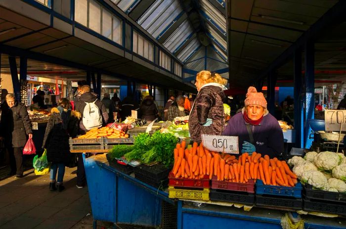 A woman offers fresh produce during the autumn season at Sofia's Ladies’ Market