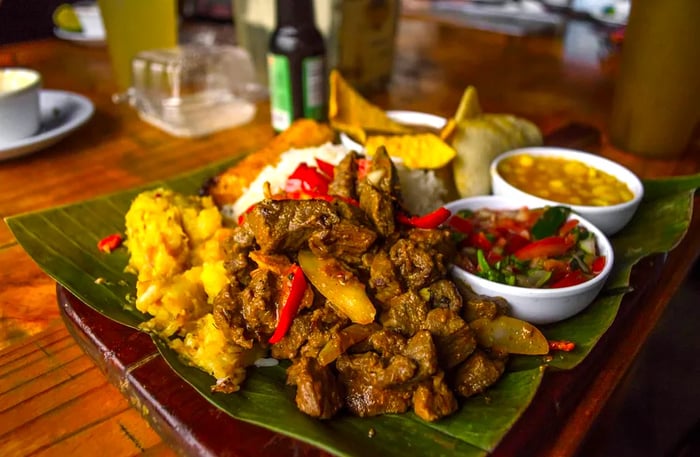 A banana leaf is laid out with a selection of traditional Costa Rican dishes.