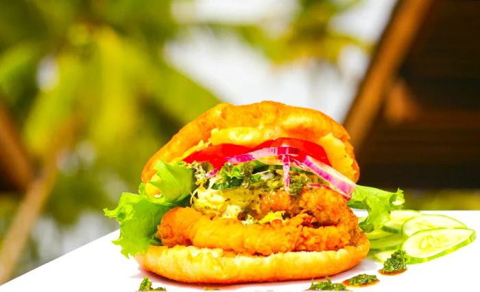 A Trinidadian specialty, bake and shark, served alongside a vibrant array of fresh fruits and vegetables.