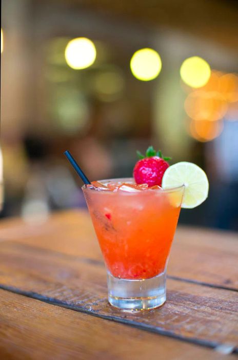 A beautifully crafted pink cocktail at a bar in Los Angeles during sunset.