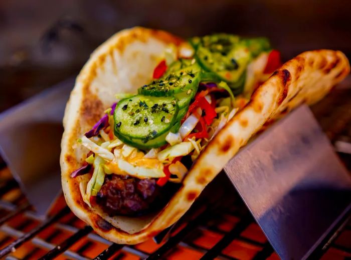 A veggie wrap served in a metal holder.