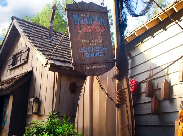 A large wooden shack with a sign at a Disney theme park.