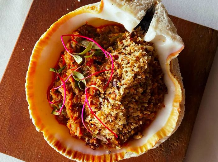 A large clam shell filled with a savory rice dish