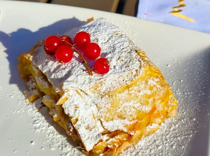 A hearty slice of strudel adorned with fresh berries.