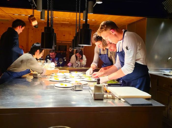 Chefs operate in a transparent kitchen space.