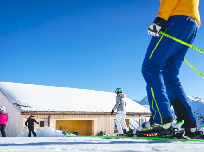 Skiers make their way to a spacious mountain hut (restaurant).