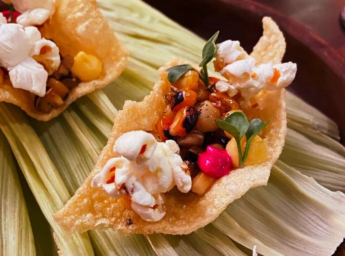 A twisted chip filled with beans, vegetables, and popcorn.