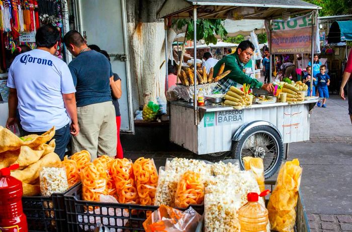 Food vendors offering corn in Hidalgo Park, the main square of Guadalajara, Mexico