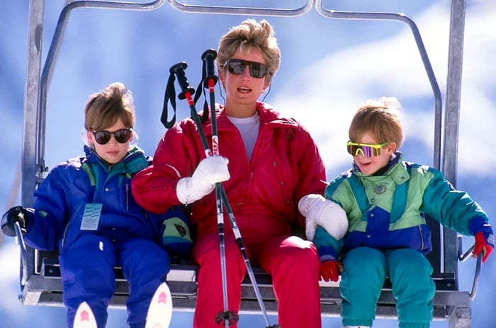 A nostalgic photograph capturing Princess Diana of Wales with Prince William and Prince Harry as they ride a ski chair lift.