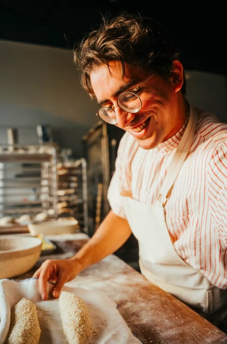 A close-up shot of a baker preparing dough.