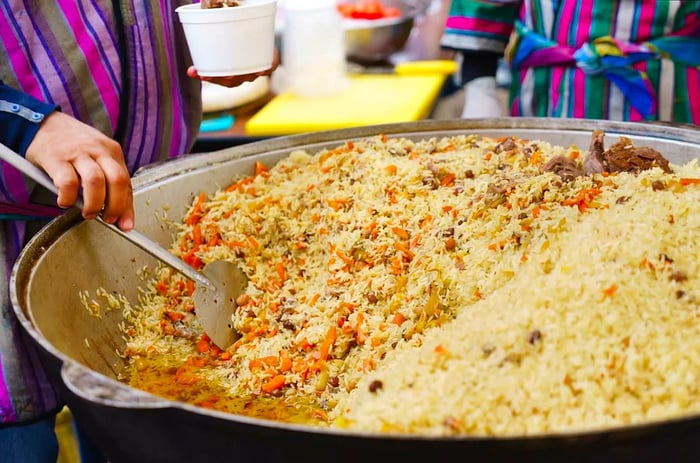 A woman preparing Plov, the national dish of Uzbekistan