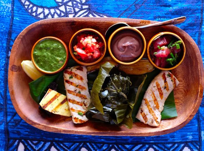 A beautifully arranged platter of fish accompanied by an assortment of side dishes.