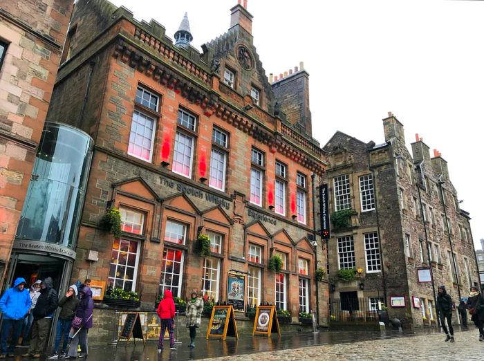 People strolling through the streets of Edinburgh on a rainy day