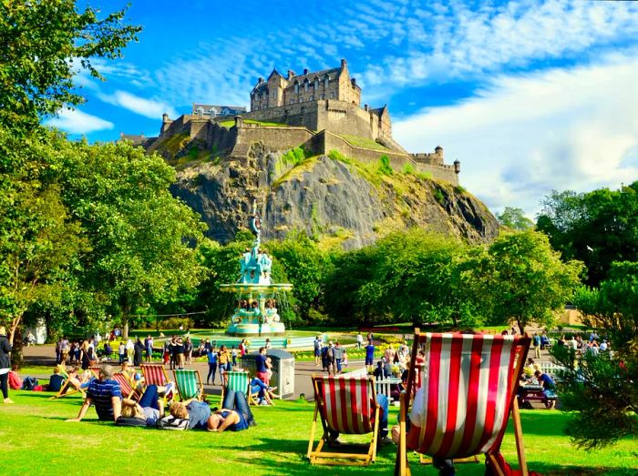 Relaxing on the grass near Ross Fountain in Princes Street Gardens, with Edinburgh Castle looming in the background.