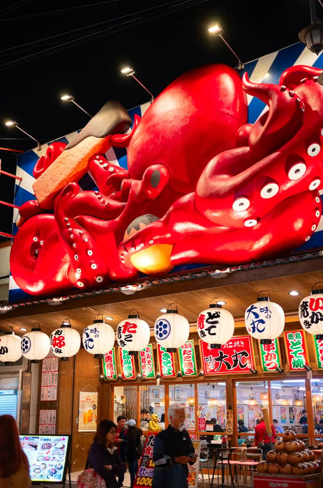 A restaurant sign featuring a large, three-dimensional octopus. 