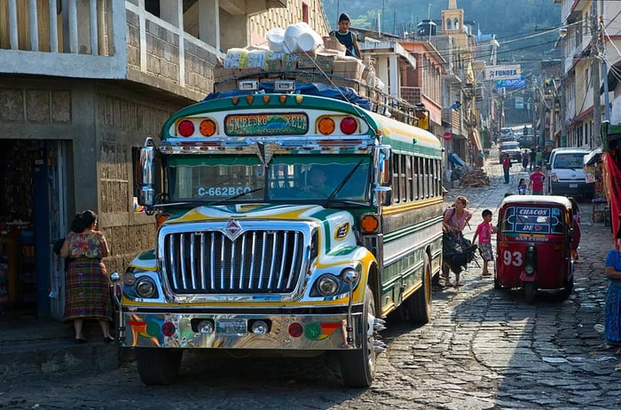 Villagers are seen loading goods onto a Guatemalan 'chicken bus' in San Pedro la Laguna.