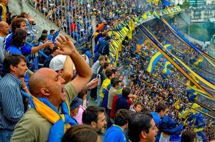 Supporters clad in blue and yellow rallying for their team at La Bombonera Stadium in Buenos Aires, Argentina