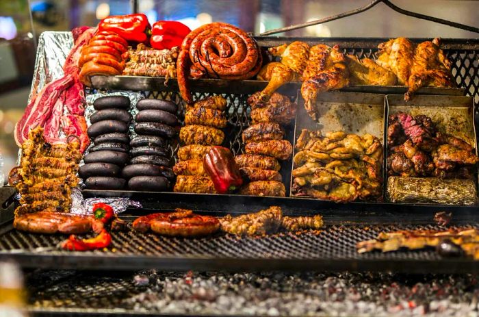 Sausages and other meats sizzling on an asado grill at Central Market, Montevideo, Uruguay, South America.