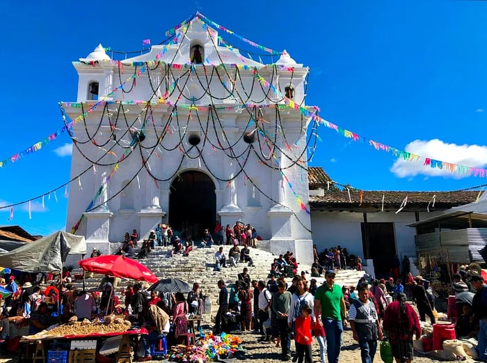 Community members assemble on the steps of the basilica in Chichicastenango during the Saint Thomas festival.