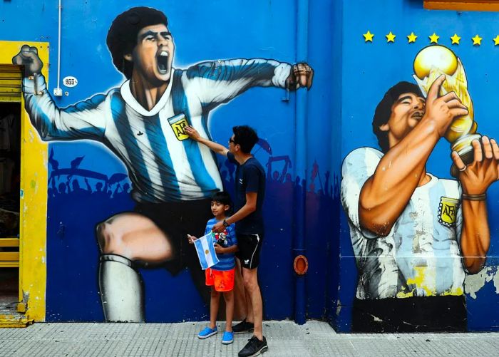 Fans pay their respects at a soccer mural in La Boca, Buenos Aires