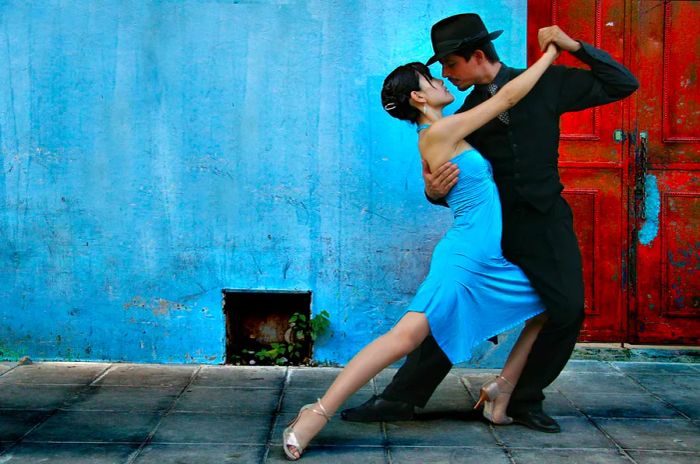 Tango performers showcasing their skills on the streets of La Boca, Buenos Aires.