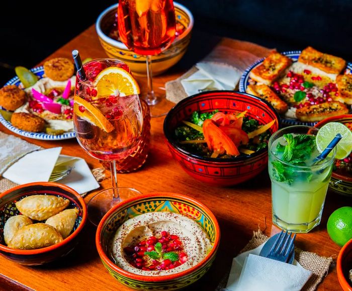 A table filled with a variety of dishes and drinks.