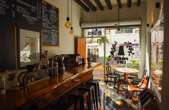 An afternoon view of the cafe interior, softly lit and inviting, yet empty.