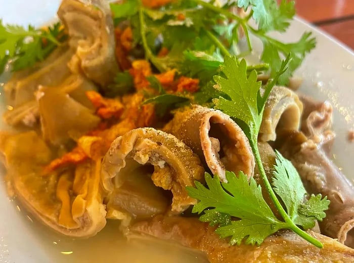 Tender curls of pork intestines with crispy fried garlic and cilantro in a delicate broth.