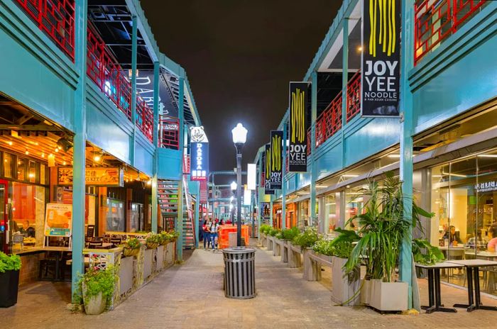 A narrow street lined with restaurants spanning two levels in Chinatown, Chicago.