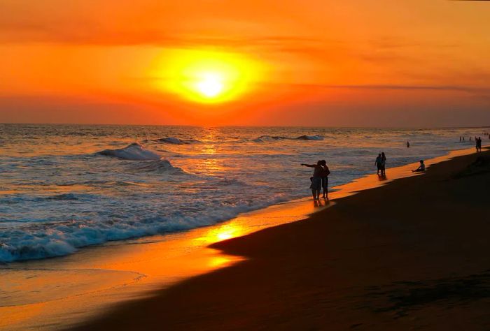 Stroll along the beach in Monterrico, Guatemala, as the sun sets.