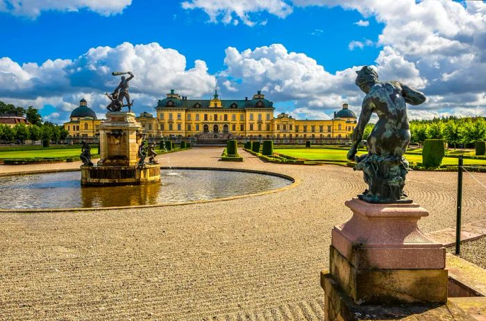 Elegant fountains and statues grace manicured gardens, with a sprawling pastel-yellow palace in the background.