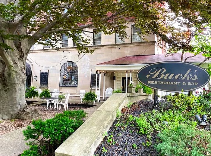 The sign for Buck’s Restaurant prominently displayed outside the establishment