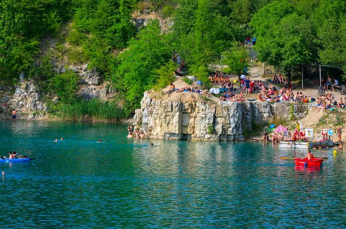 Lagoon Zakrzówek in an old limestone quarry, emerald water, resting people