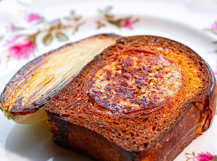 A loaf cut open to reveal a generous sausage inside.