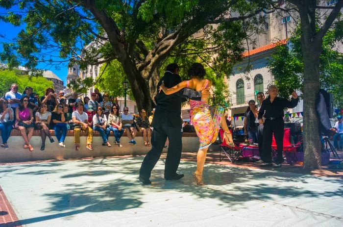 A couple performs tango during a street show in the San Telmo neighborhood of Buenos Aires.