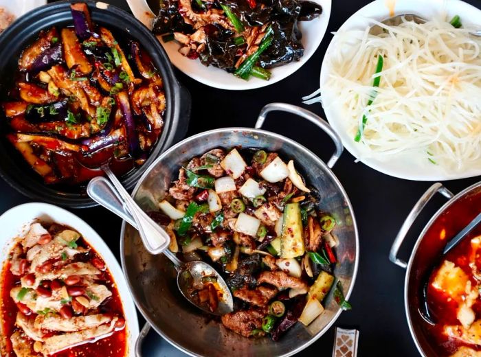 An overhead view of a table laden with various dishes.