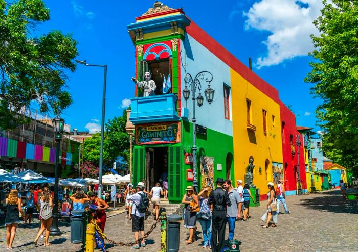 Tourists exploring the iconic colorful houses of La Boca, Buenos Aires.