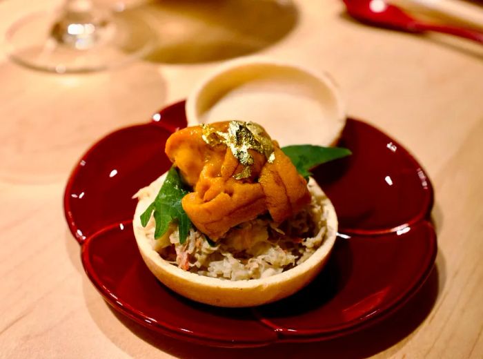 A small dish piled high with uni and various toppings.