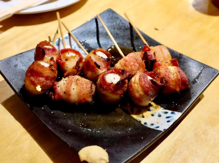 A plate of skewers featuring quail.