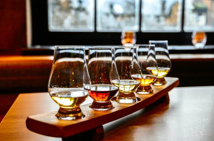 Glasses of Scotch whisky await sampling during a distillery tour in Scotland.