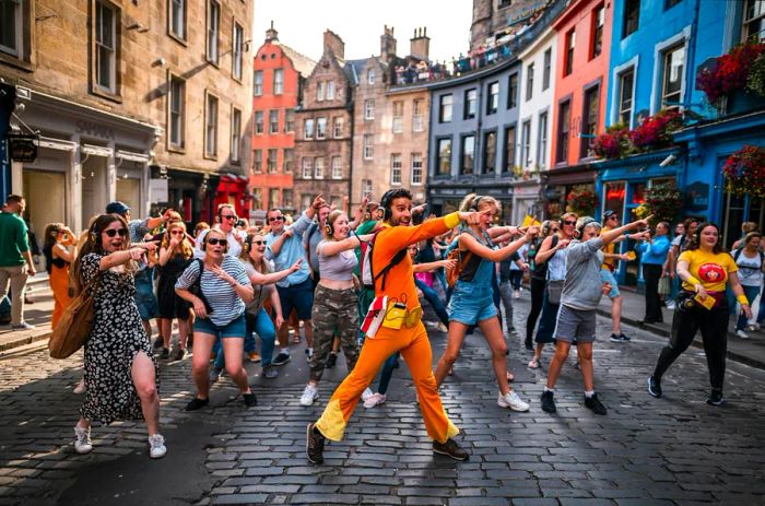 Festival-goers reveling in the Guru Dudu Silent Disco during the Edinburgh Fringe Festival.