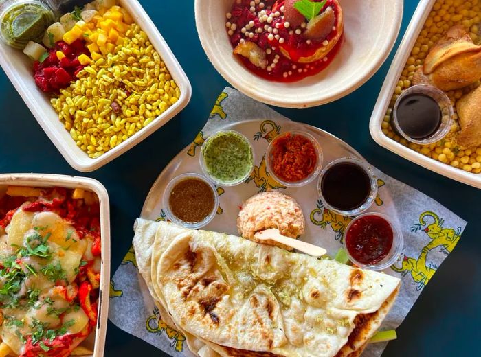 A selection of dishes featuring naan, rice meals, and flavorful sauces.