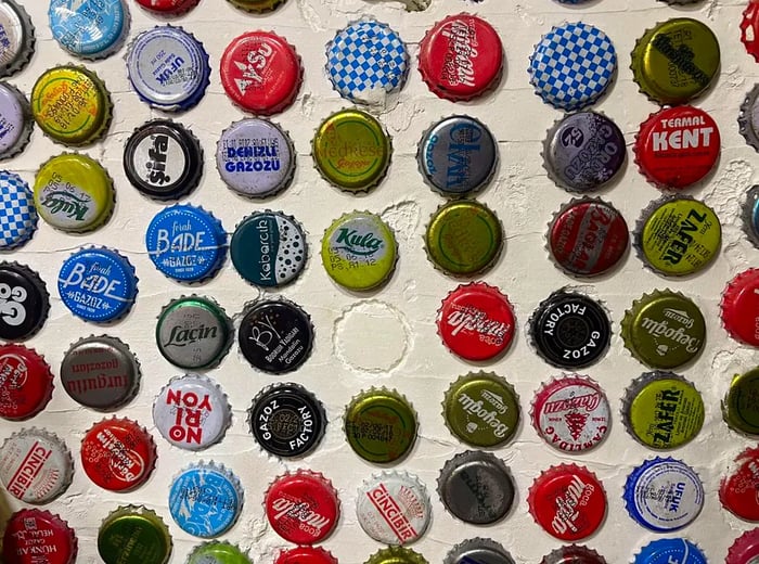 Vintage gazoz bottle caps from various brands.