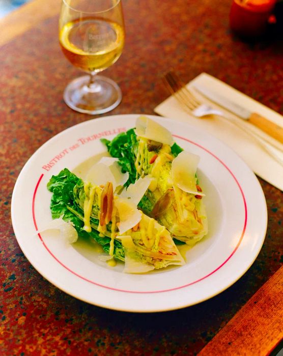 A salad featuring crisp lettuce wedges dressed with vinaigrette.